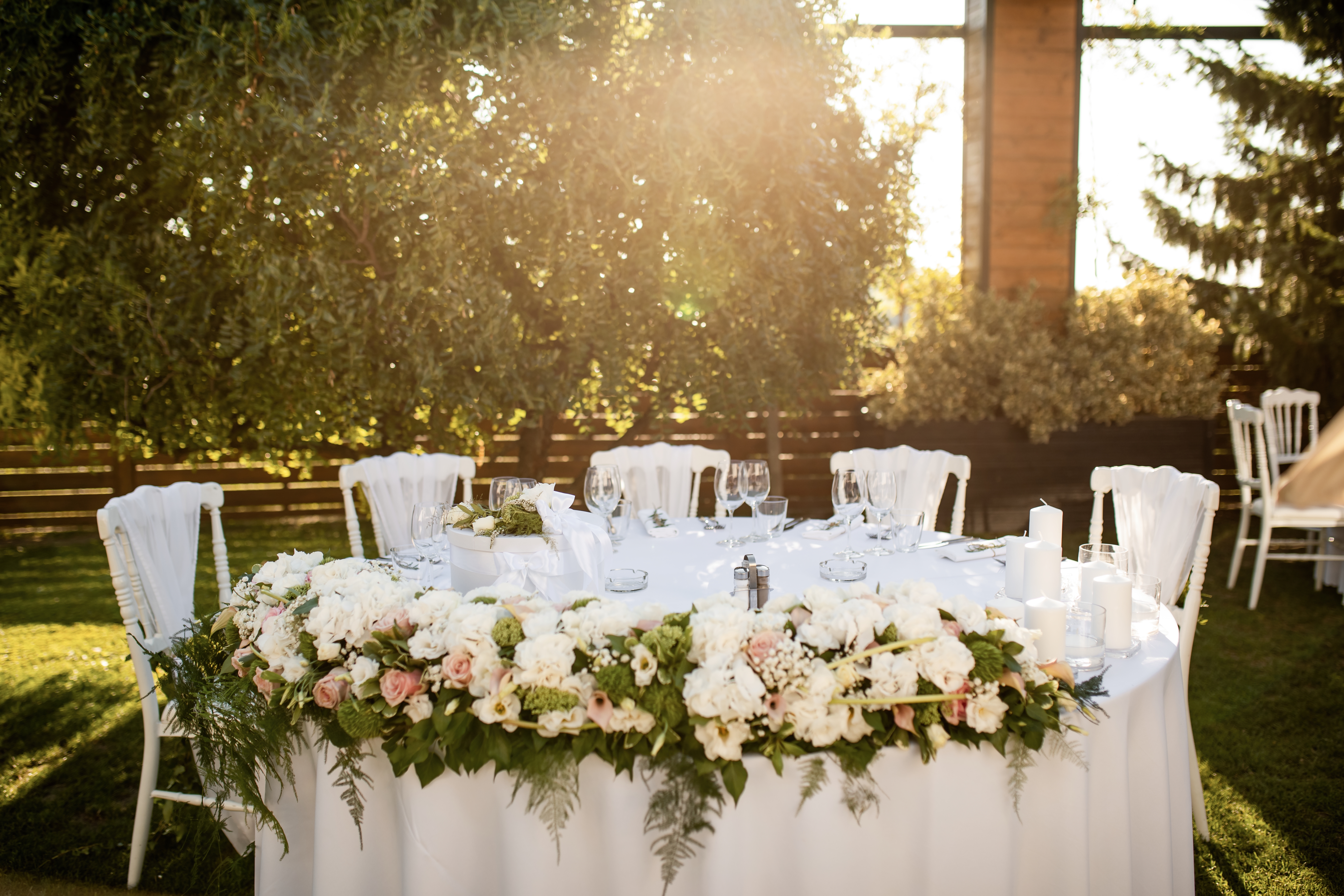 White event tent set up for an outdoor wedding reception